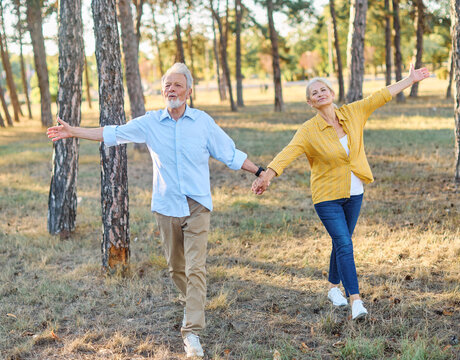 Happy active senior couple meditating and daydreaming and relaxing and nature outdoors