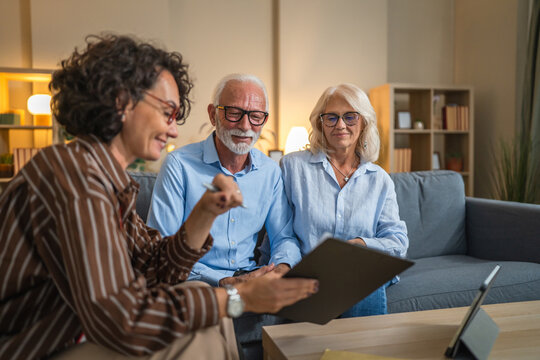 Senior couple engaged in negotiations with a consultant or agent