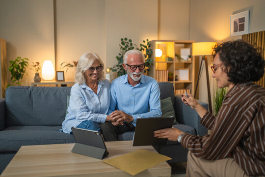 Senior couple engaged in negotiations with a consultant or agent