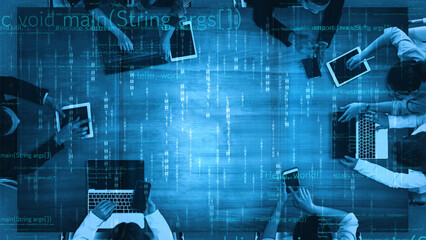 A vibrant modern office scene shows diverse individuals engaged in coding and programming on laptops and mobile devices. Digital code overlays enhance the tech-focused atmosphere. Xenic