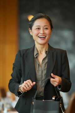 Young asian female financial consultant in a boardroom meeting clients
