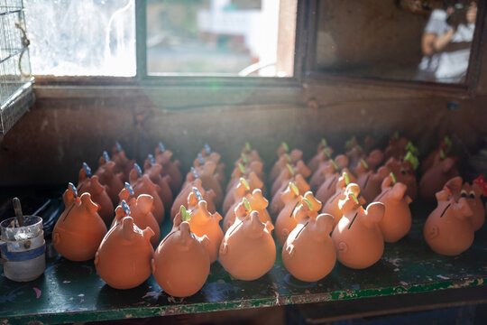 Clay piggy banks in pottery workshop