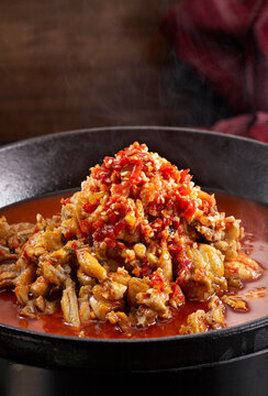 Close-up of super spicy braised frog meat in a wok