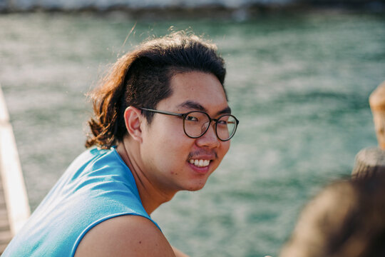 Young Man Enjoys a Sunny Day At The Sea