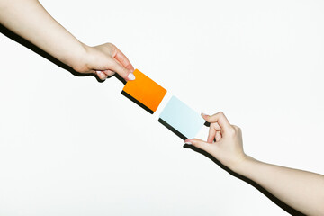 Conceptual symbolic photo of money transfer: two hand holding cards