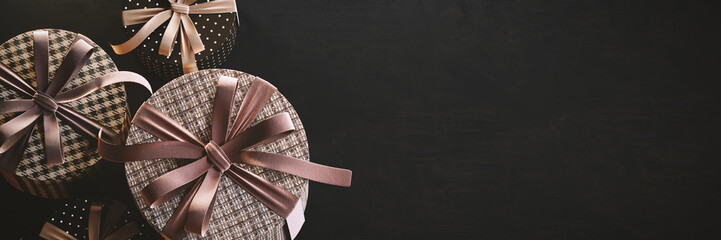 Presents. Variety of gift boxes with empty dark grunge wall background. 3D Rendering, 3D Illustration	
