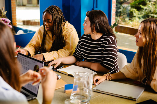 Female entrepreneurs focused on a presentation during a meeting
