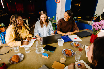 Modern industrial coworking with a group of women engaged in a meeting