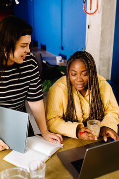 Diverse women chat in a friendly workspace at a creative industry