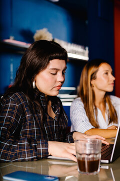 Professional woman using a laptop during a collaborative meeting