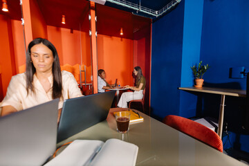 Super wide angle shot of multiple teams working in a women-led office