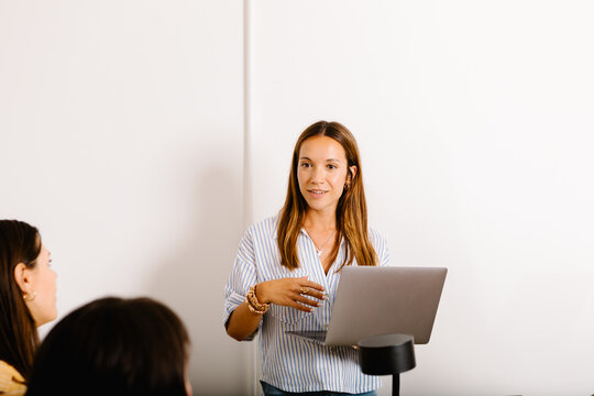 Female professional leading collaborative meeting with women creatives