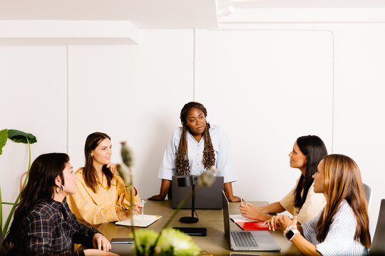 A black female professional conducting a collaborative meeting
