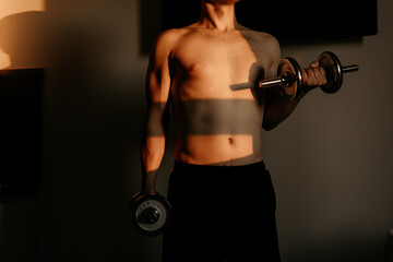 Unrecognizable Bodybuilder Doing Overhead Dumbbell Press at Sunset