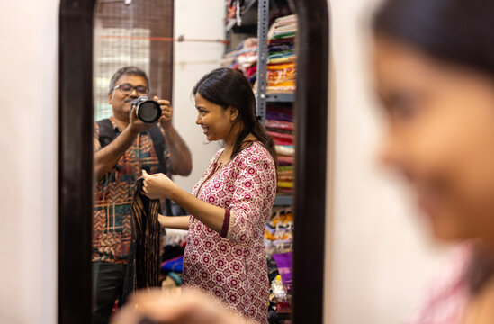 Young Girl is giving trial with traditional sari dress