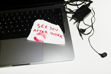 Xoxo love message and red lipstick stain on paper on laptop keyboard