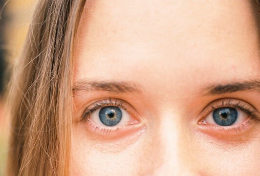 Close-up of woman&rsquo;s blue eyes with natural light reflection