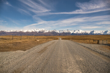 Driving up Braemar  road alongside between Lake Tekapo and Pukaki towards the snowy Mount Cook mountain ranges