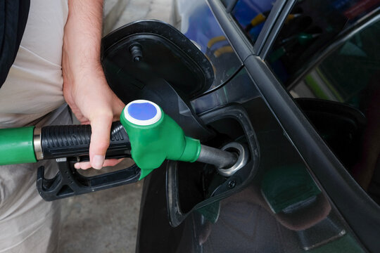 Hand Refueling Car at Gas Pump