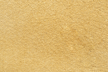 Smooth texture of beige wall surface showcasing warm color tones and subtle patterns ideal for backgrounds and design projects