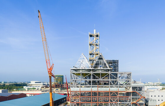 Factory Construction with Steel Framework and Cranes
