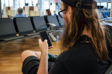 Traveler Browsing Phone at Airport