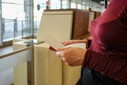 Holding Boarding Pass and Passport