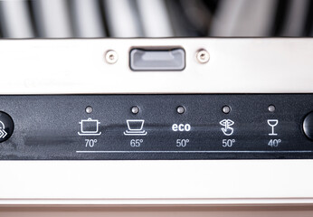 Control panel of built-in dishwasher features temperature settings and an eco cycle button for optimal dishwashing performance