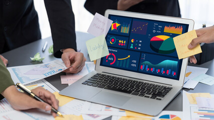 Analyst team use sticky note for creative and analytic brainstorm for business idea with BI data dashboard on laptop screen. Analysis financial data visualization tech for marketing strategy. Prodigy