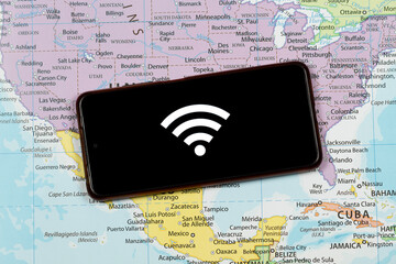an a smart phone with a white wifi symbol over a north american map