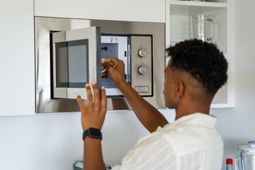 Homeowner using microwave oven