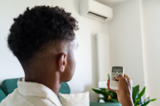 Man adjusting air conditioning temperature 