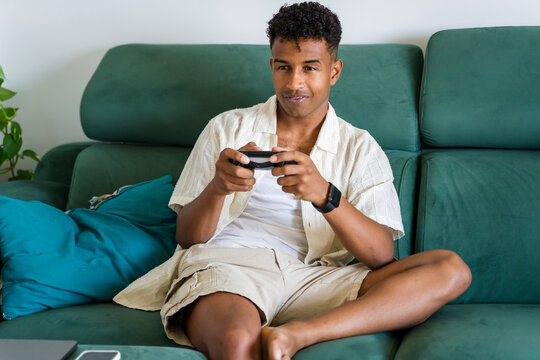 man playing video games at home