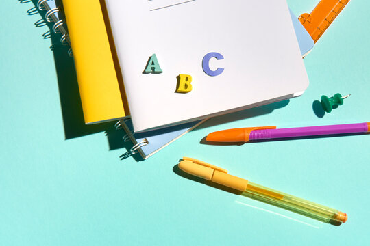 School Supplies Close Up on Light Blue Background with Copy Space.