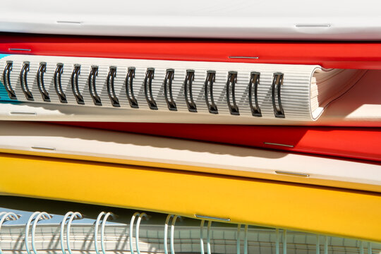 Stack of Various Colorful Spiral Notebooks 