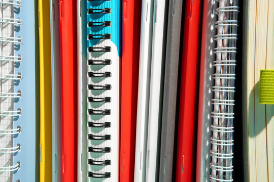 Stack of Various Colorful Spiral Notebooks 