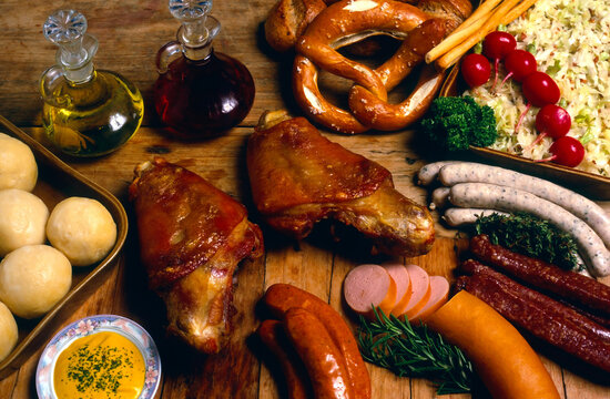 Delicious variety of German sausages and pork hock displayed with traditional sides