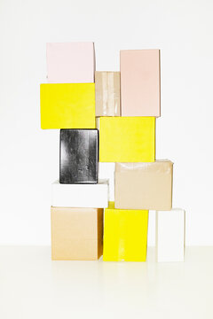 Photo of various size and colour mockup boxes in piles with space text