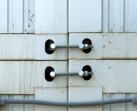 Close-Up of Industrial Bolts and Cables on a Metal Structure