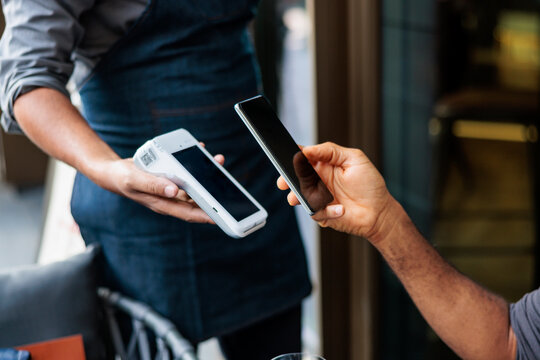 Contactless payment with phone at restaurant.