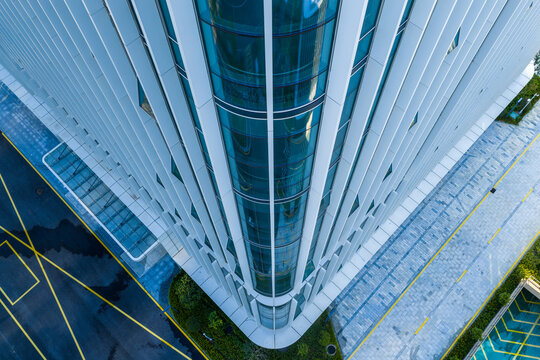 Modern glass office building facade with reflections