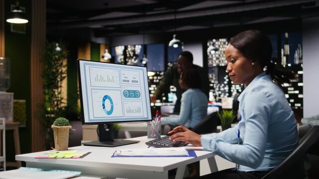 Businesswoman focused on proofreading and planning project data for objectives achievement, solving tasks late at night in the dark office. Executive insight on budgeting and targets. Camera A.