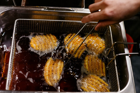 Waffle Fries Deep Frying in Hot Oil at a Restaurant Kitchen