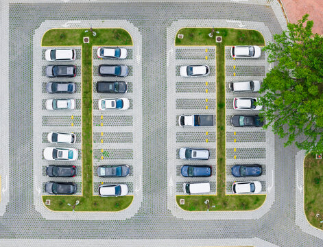 Aerial view of cars parked in organized parking lot