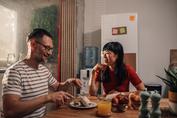 Couple enjoying breakfast together in modern kitchen