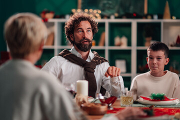 Family celebrating christmas dinner having conversation at home