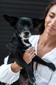 Emotive female and her loyal black dog sharing a deep connection