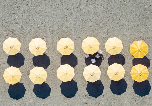 Aerial Yellow Umbrellas with Shadows on Beach Sand