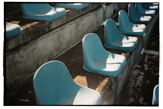 Blue Plastic Seats on Concrete Bleachers