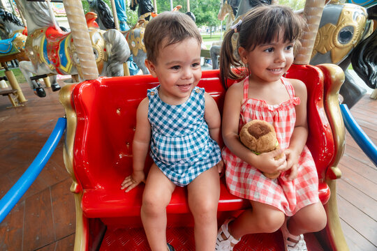 Brothers enjoying carousel ride 